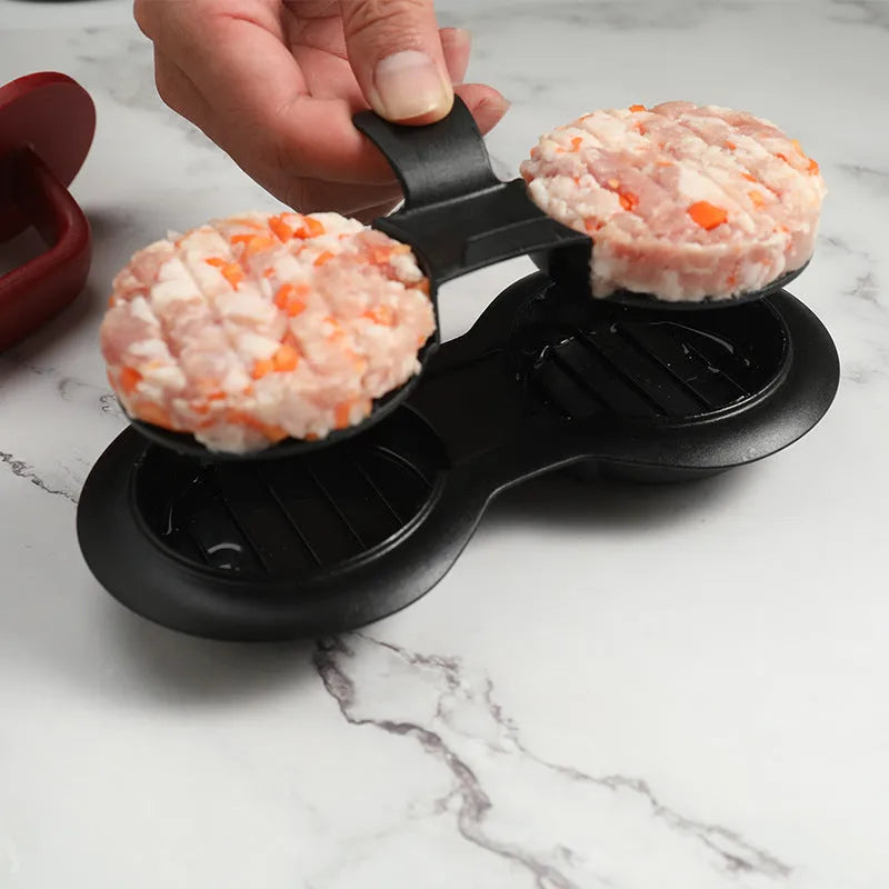 Black and red round plastic burger press for making uniform patties.