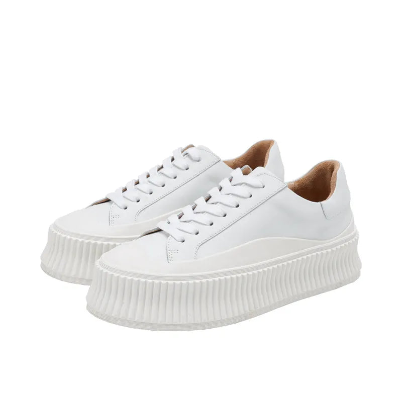 Women's black suede platform trainers with thick rubber sole and back lacing.