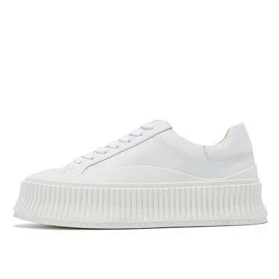 Women's black suede platform trainers with thick rubber sole and back lacing.