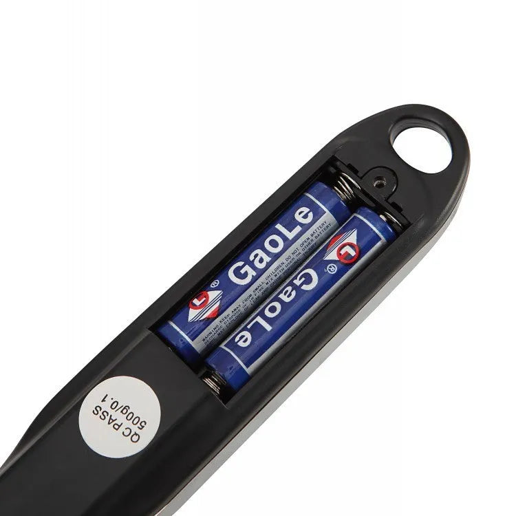 Digital kitchen measuring spoon with LCD screen showing weight measurement