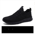 Men's black and white mesh sport sneakers with round toe and lace-up closure