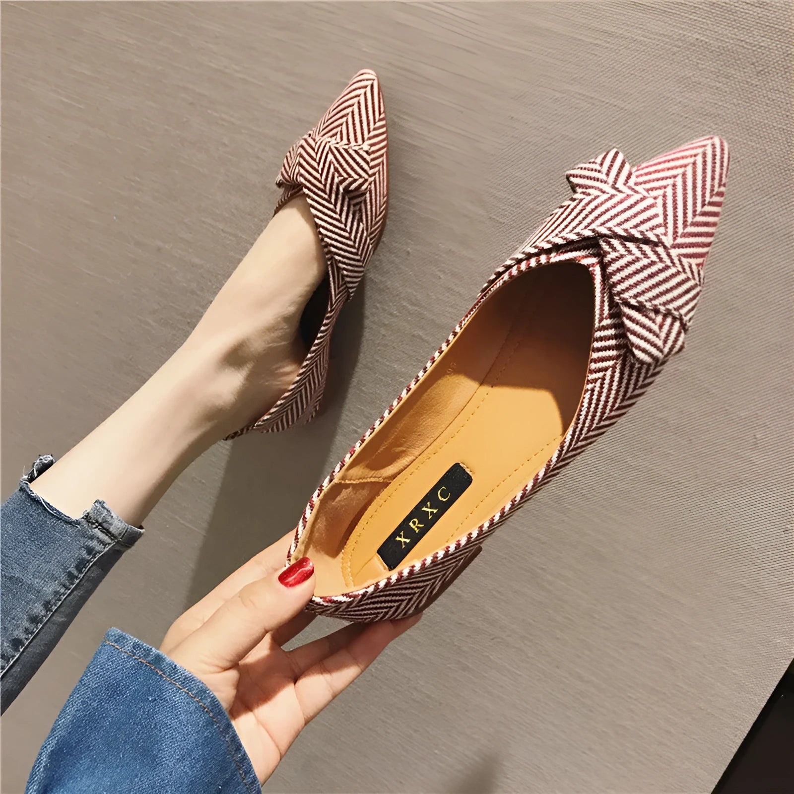 Red and black women's pointed toe flat shoes with a shallow mouth design and low flat heel.