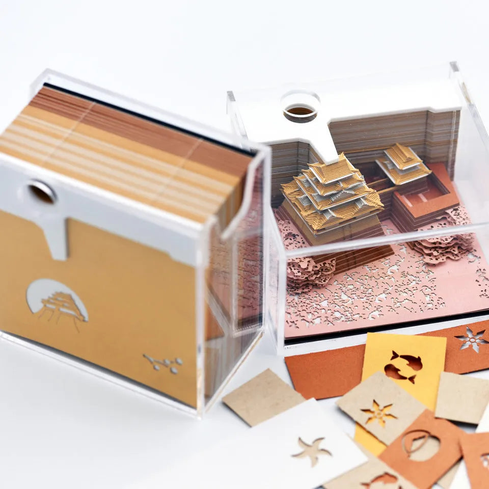 Three-dimensional specialty paper model of the Tianshou Tower from Spirited Away on a desk.