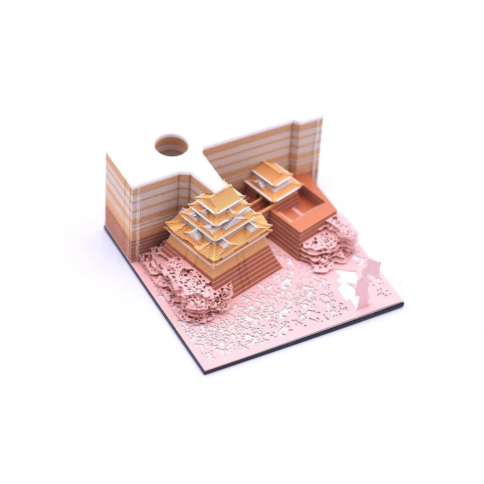 Three-dimensional specialty paper model of the Tianshou Tower from Spirited Away on a desk.