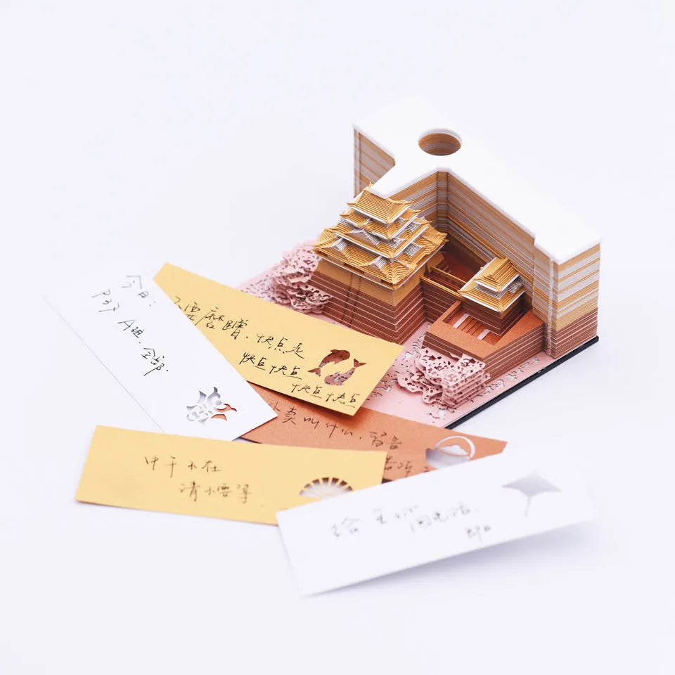 Three-dimensional specialty paper model of the Tianshou Tower from Spirited Away on a desk.