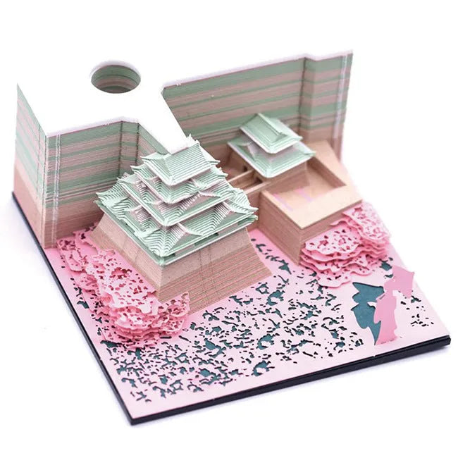 Three-dimensional specialty paper model of the Tianshou Tower from Spirited Away on a desk.