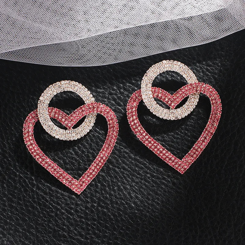 Heart-shaped alloy earrings with diamond-cut finish, 5.8cm x 4.6cm, in pink or green, 20g pair.