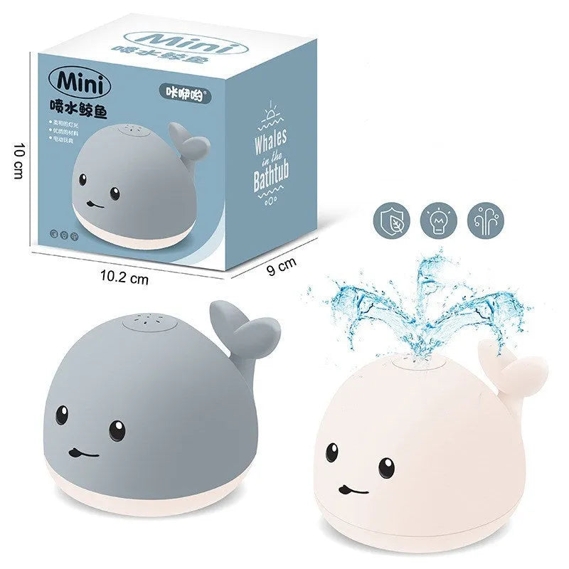 Grey and white whale bath toy spraying water with LED lights flashing
