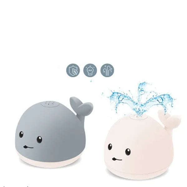 Grey and white whale bath toy spraying water with LED lights flashing