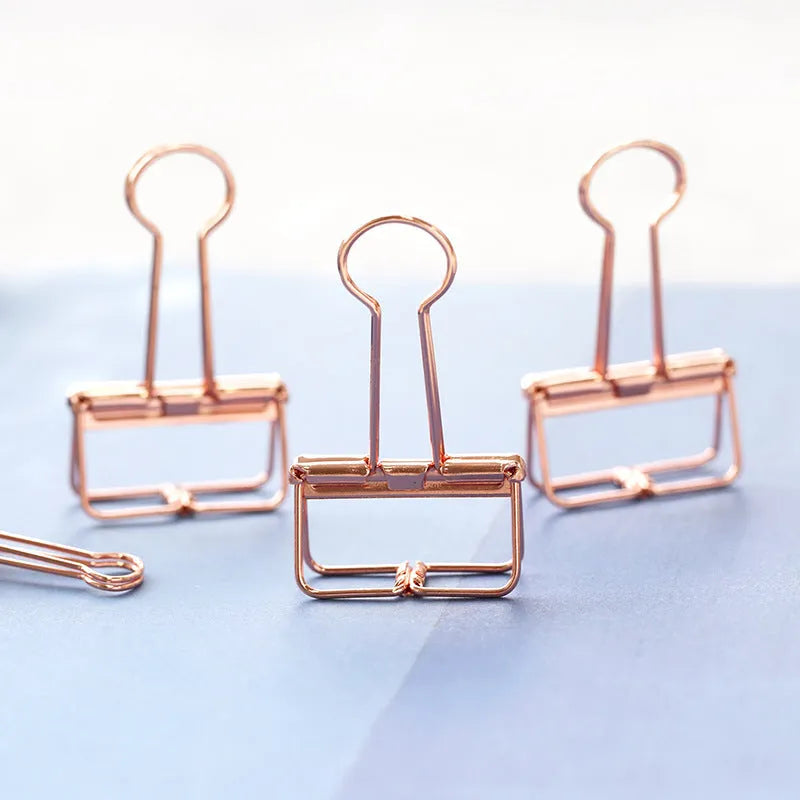Rose gold metal binder set showing small and large binders for ticket and document storage