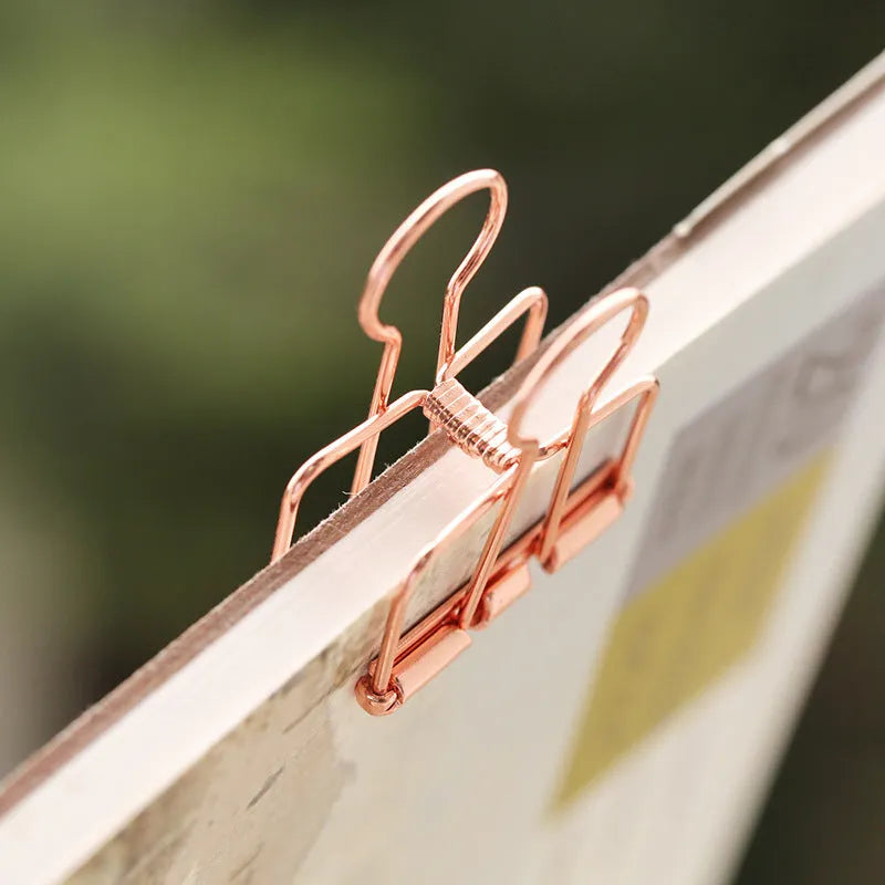 Rose gold metal binder set showing small and large binders for ticket and document storage