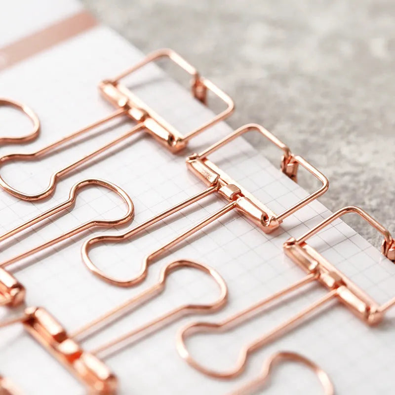 Rose gold metal binder set showing small and large binders for ticket and document storage