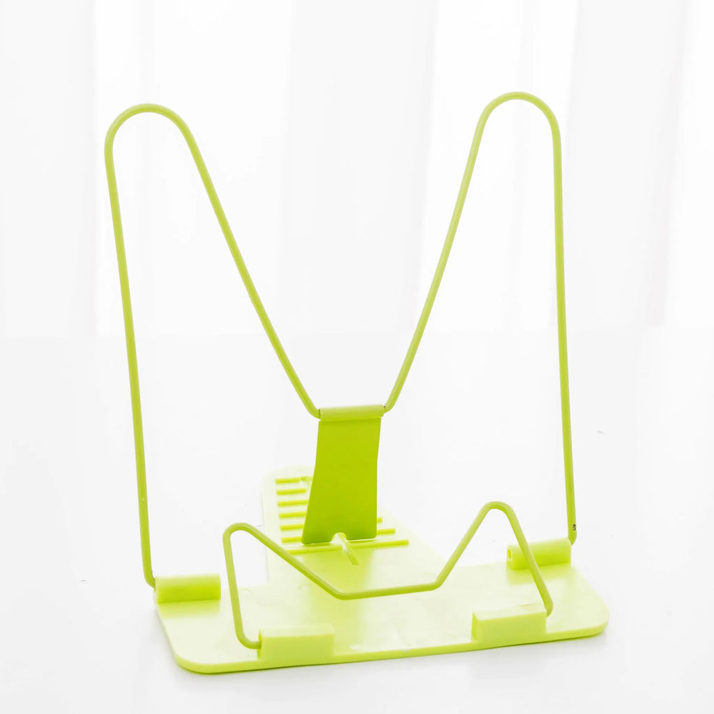 Multifunctional metal and plastic reading frame in blue colour on a desk holding a book upright.