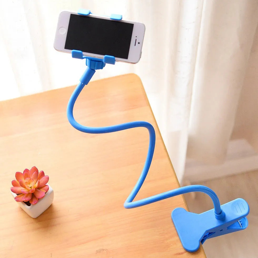 Black portable phone holder with long flexible arm and V-clip mounted on a bed frame.