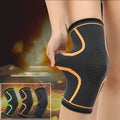 Men's thin sports knee pads in black with orange trim, designed for running and basketball