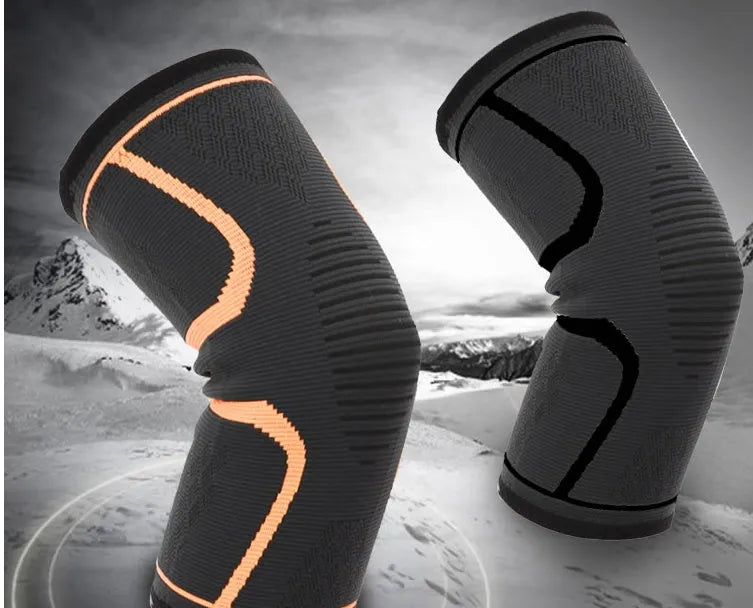Men's thin sports knee pads in black with orange trim, designed for running and basketball