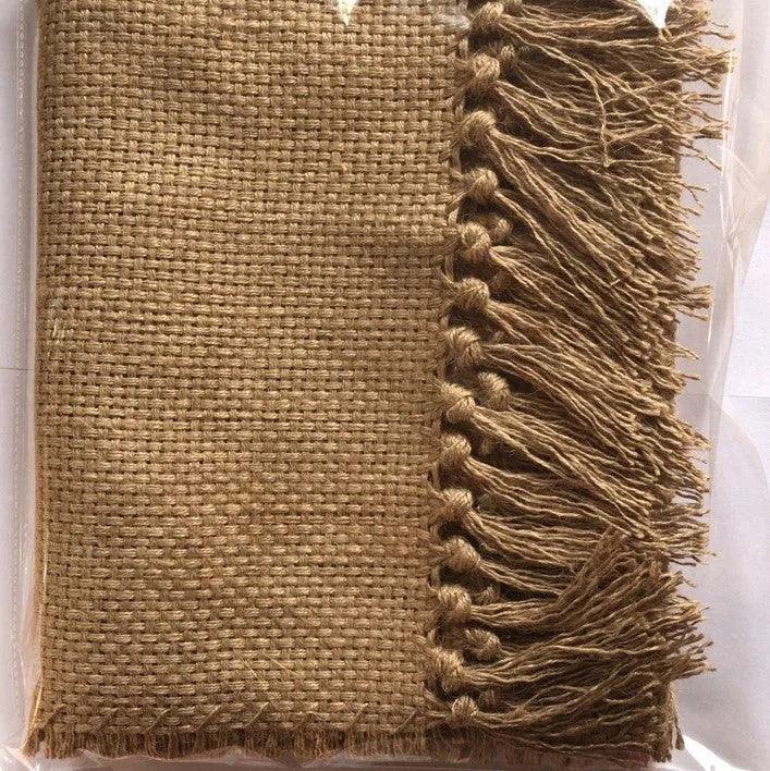 Yellow jute area rug with handmade fringed edges and non-skid backing, available in multiple sizes.