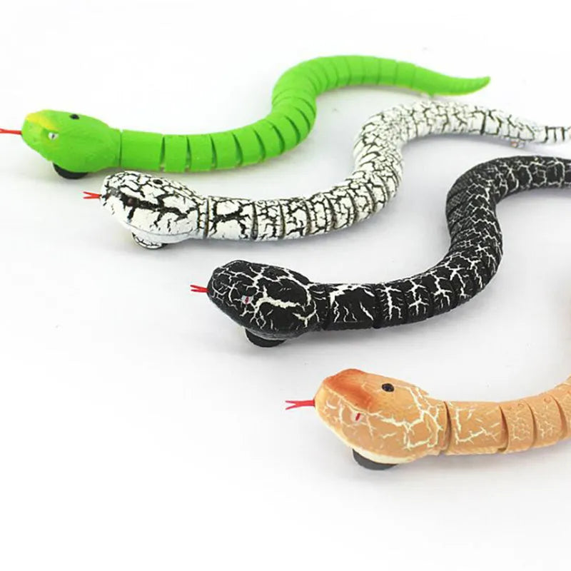 Black and grey remote control cobra snake toy on floor with USB charging cable and remote.
