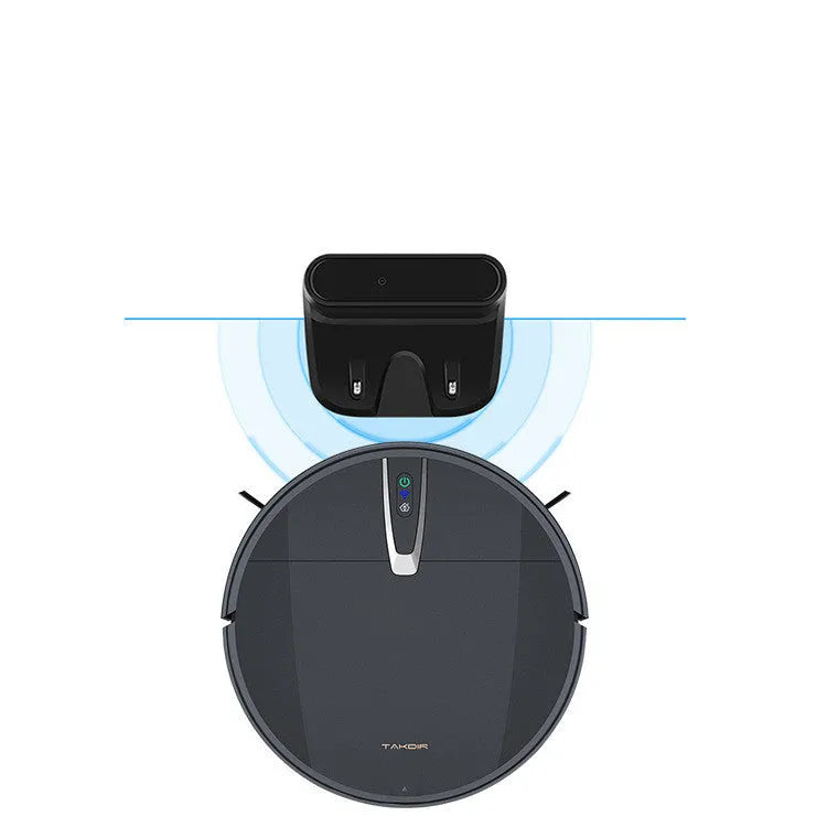 Black and white robotic floor cleaner with charging base, remote control, mop, and water tank on a hardwood floor.