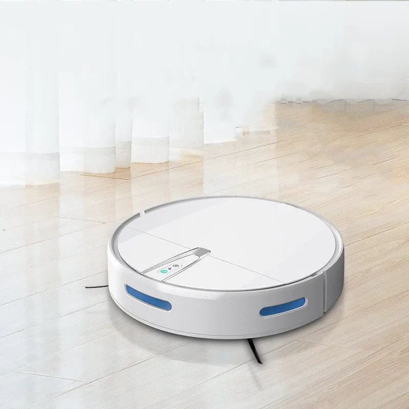 Black and white robotic floor cleaner with charging base, remote control, mop, and water tank on a hardwood floor.