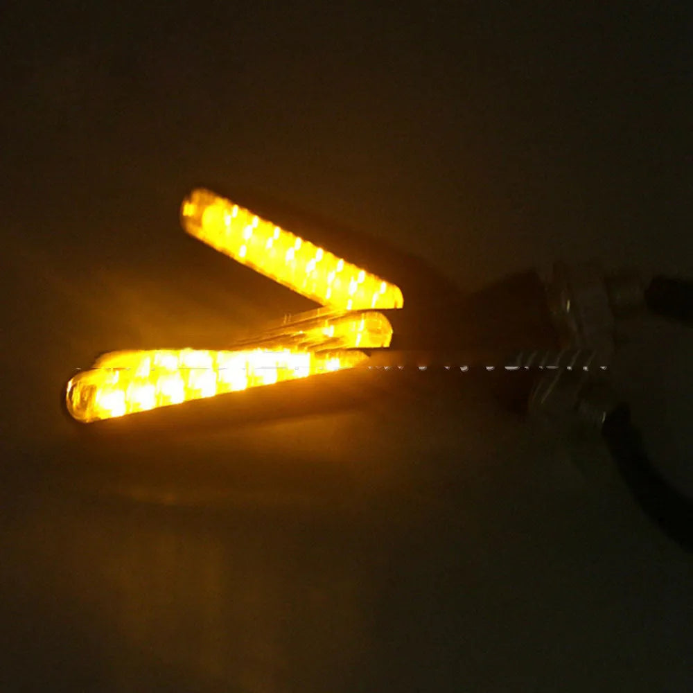 12V motorcycle LED turn signal with black ABS shell and amber yellow light, shown as a single unit