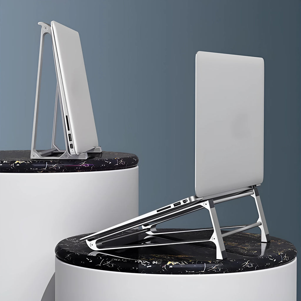 Aluminium alloy laptop stand with increased storage in dark gray, holding a laptop on a desk