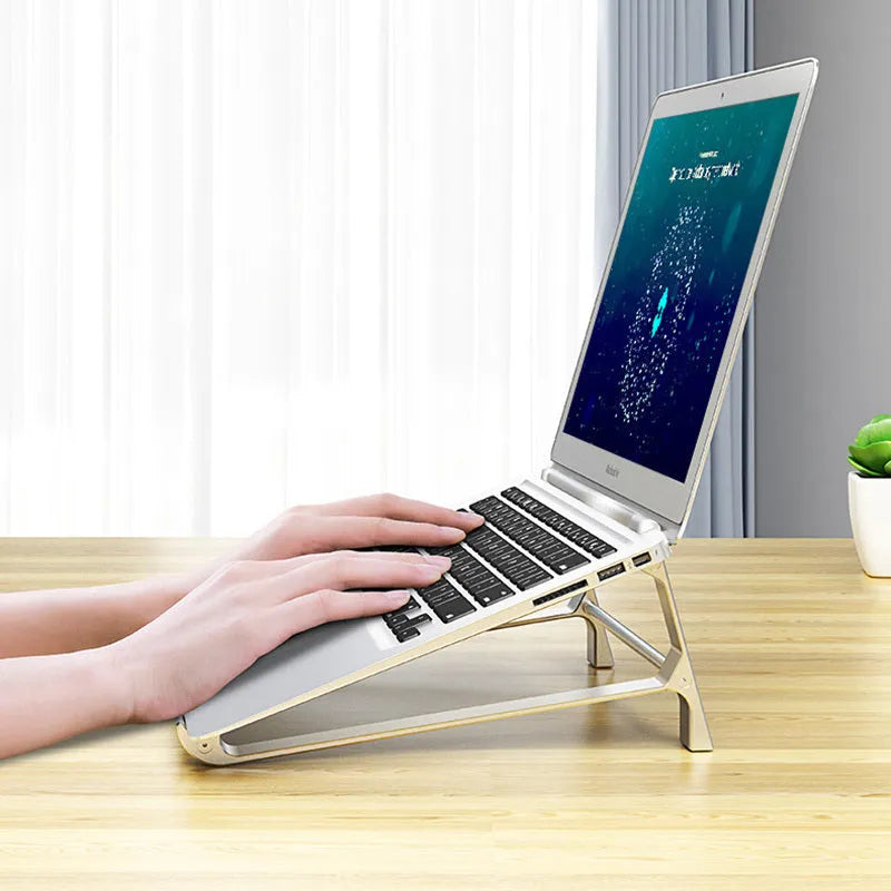 Aluminium alloy laptop stand with increased storage in dark gray, holding a laptop on a desk