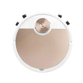 Golden coloured robotic vacuum cleaner with remote control on a hardwood floor.