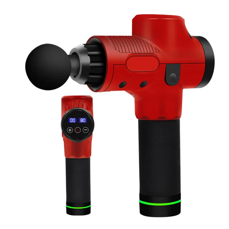 Black electric muscle massage gun with multiple interchangeable heads on a table.