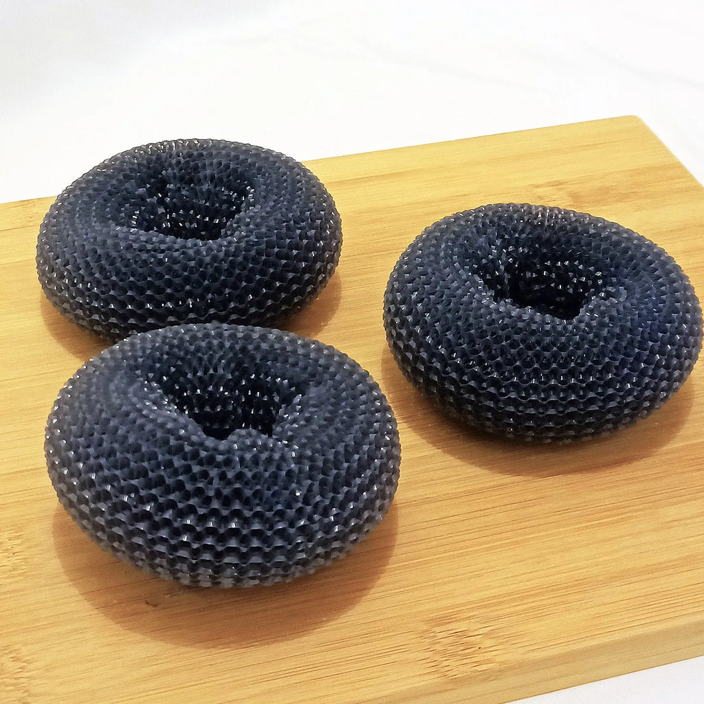 Push-type kitchen soap dispensing scrubber brush with PET construction on a kitchen counter.
