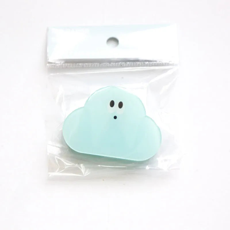 Acrylic decorative clip with cartoon collage design for scrapbooking, shown in beige, blue, orange, and pink.