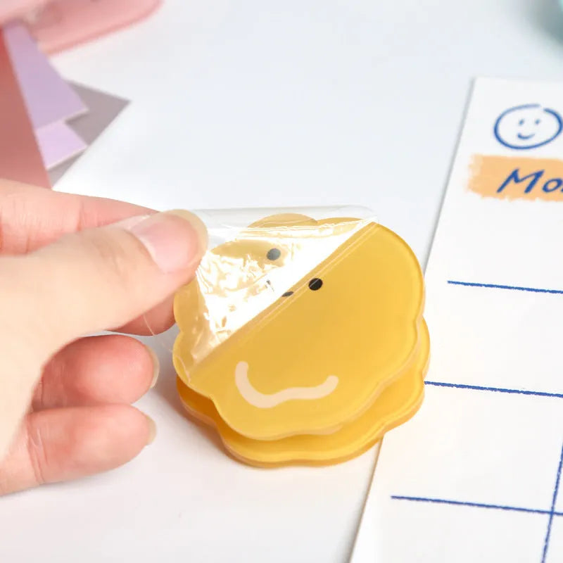Acrylic decorative clip with cartoon collage design for scrapbooking, shown in beige, blue, orange, and pink.