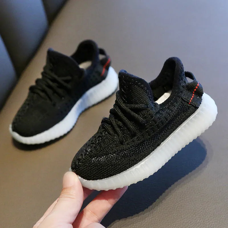Children's breathable mesh sneakers with non-slip rubber soles in black, white, grey, and orange colours