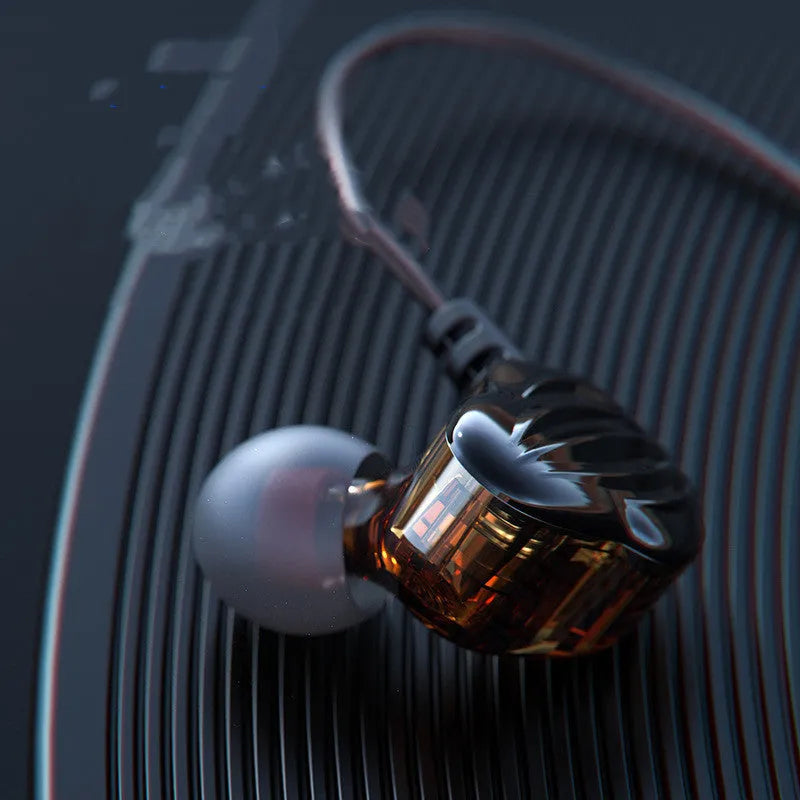 White in-ear sports headphones with black cable looped over the ear, showing the 3.5mm plug.