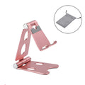 Mini folding metal mobile phone stand on a desktop in gold colour.