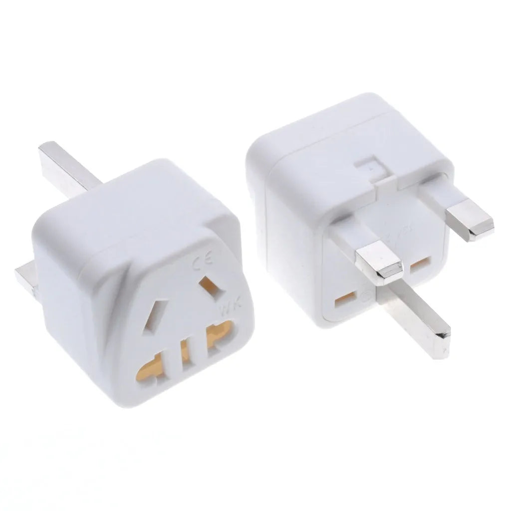 Square white international power adapter converting to five UK three-pin sockets.