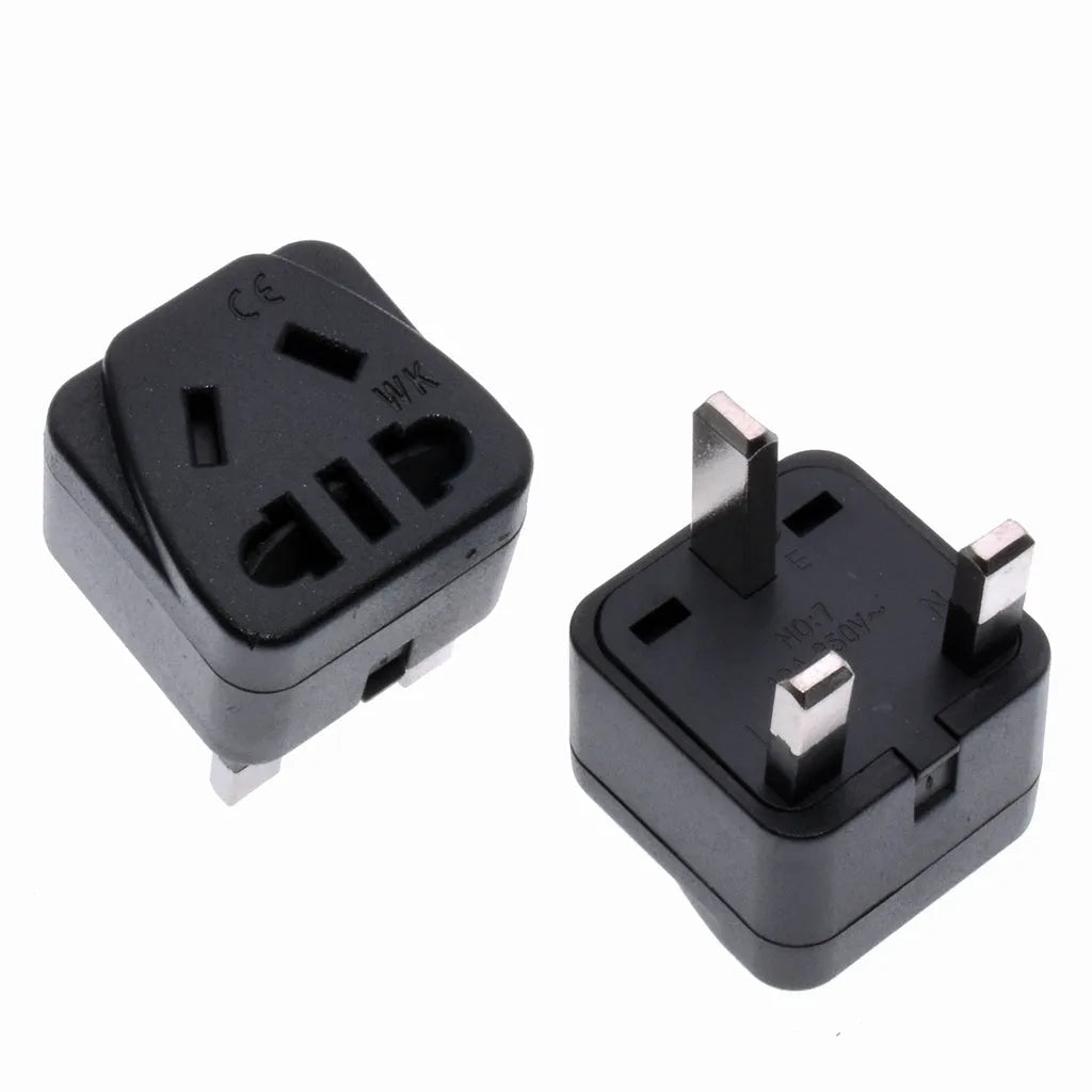 Square white international power adapter converting to five UK three-pin sockets.