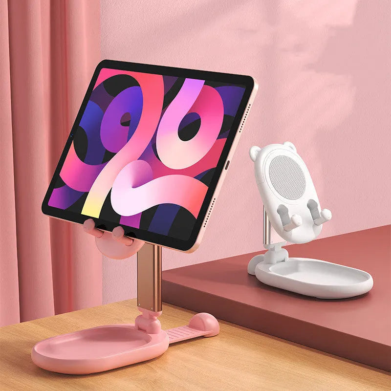 Blue foldable phone and tablet stand with a built-in mirror on a wooden desk.