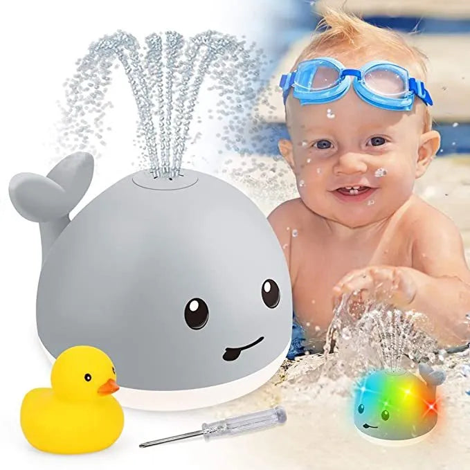 Grey and white whale bath toy spraying water with LED lights flashing