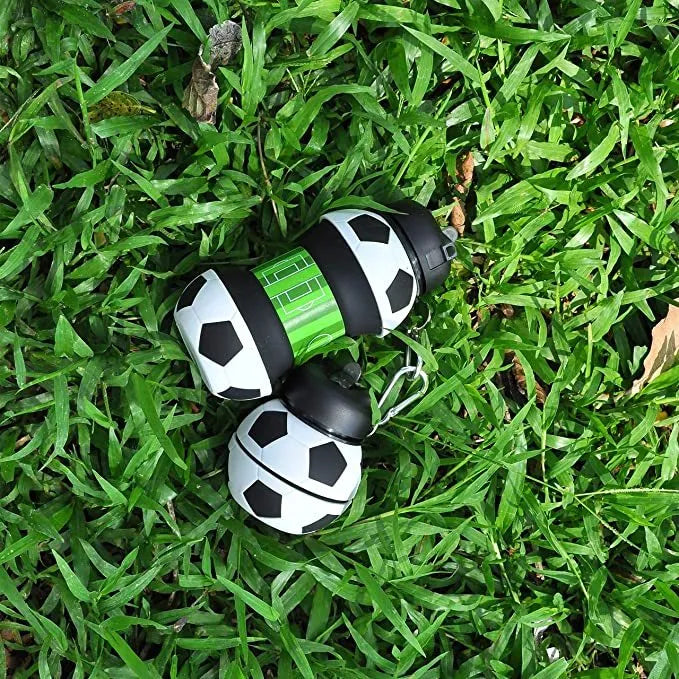Collapsible white soccer ball shaped silicone water bottle with straw and carrying clip, 18 oz capacity