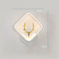 Deer antler shaped wall lamp with remote control for dimmable LED lighting in three colour temperatures.
