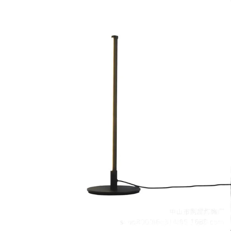 Nordic minimalism black bedside lamp with LED lighting and remote control on table
