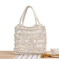 Women's woven straw beach bag with soft handles in medium square shape