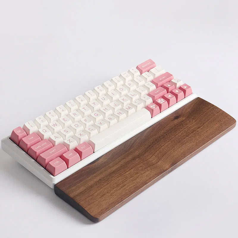 Walnut wood mechanical keyboard wrist rest showing natural wood grain and ergonomic shape