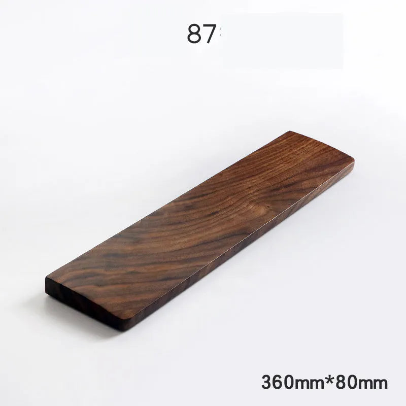 Walnut wood mechanical keyboard wrist rest showing natural wood grain and ergonomic shape