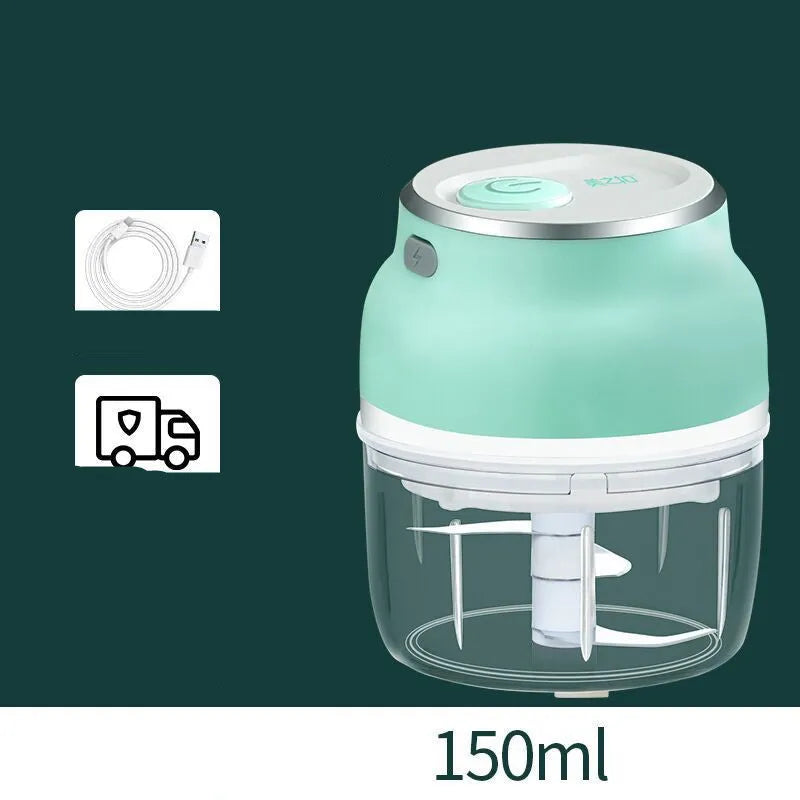 White portable electric mini food chopper with transparent cup and stainless steel blade on a kitchen counter.