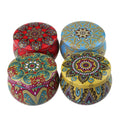 Set of four soy wax scented candles with dried flowers in cylindrical shape, 125g each, on a table