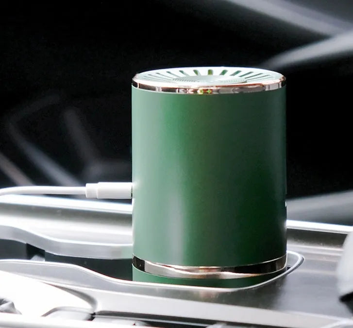 Anion car air purifier in creamy white or green with composite filter, 30 dB, USB and car power supply
