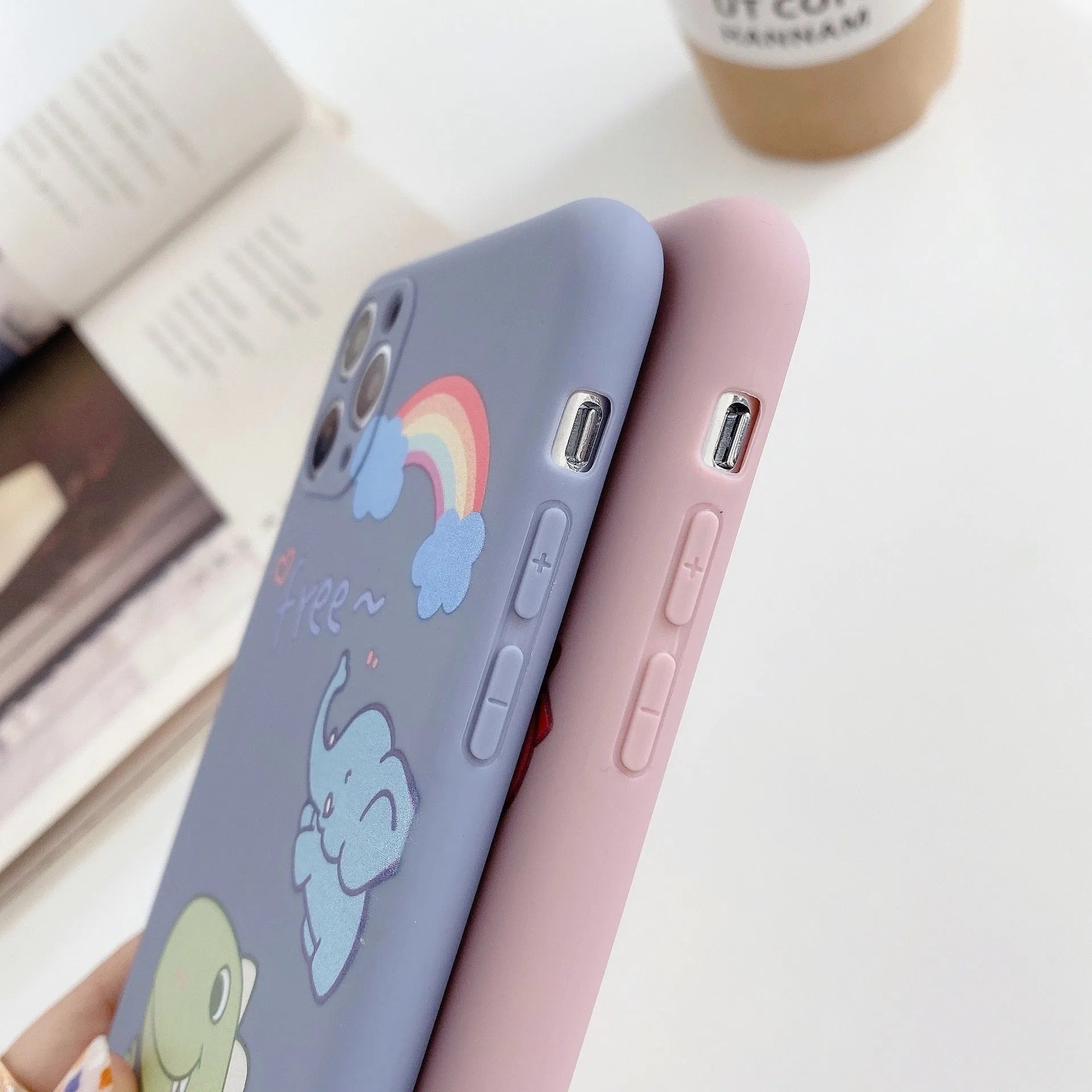 Blue frosted TPU iPhone case with a cartoon dinosaur print on the back.