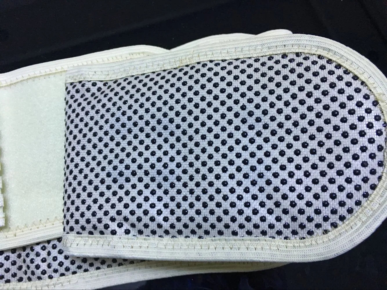A beige and black self-heating magnetic waist support belt for lumbar muscle strain, showing elastic cloth material.